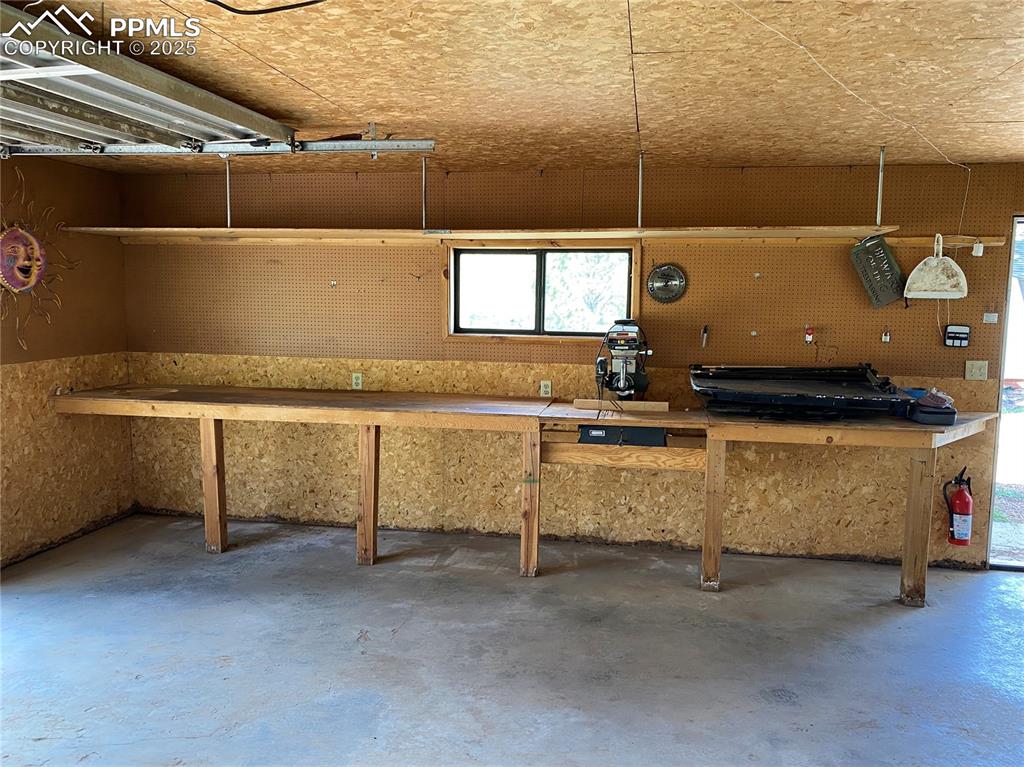 Image 32 of 36: The built-in workbench comes with a saw