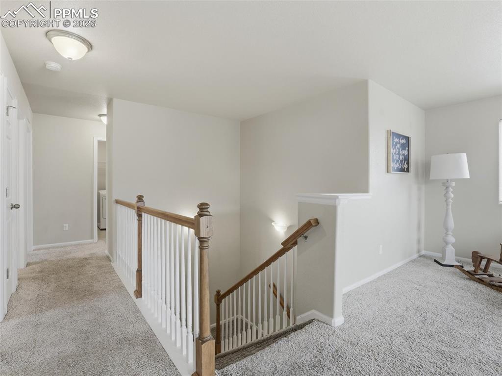 Image 20 of 45: Hall featuring carpet and an upstairs landing