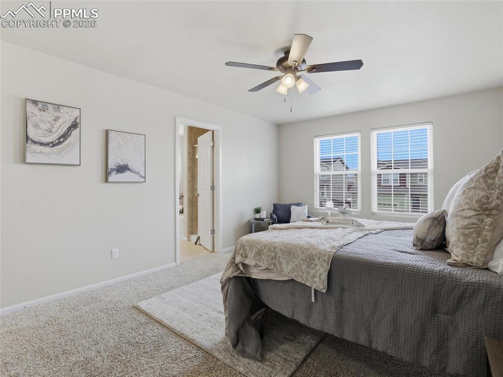 Image 26 of 45: Carpeted bedroom with baseboards and a ceiling fan