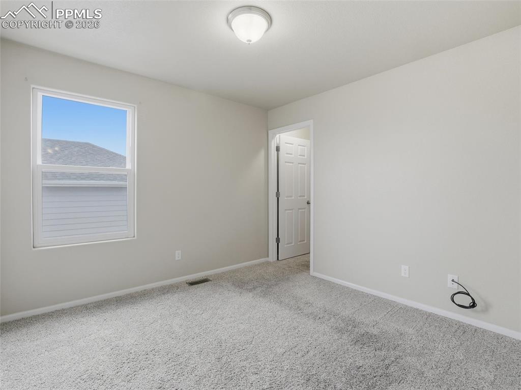 Image 33 of 45: Carpeted spare room with baseboards