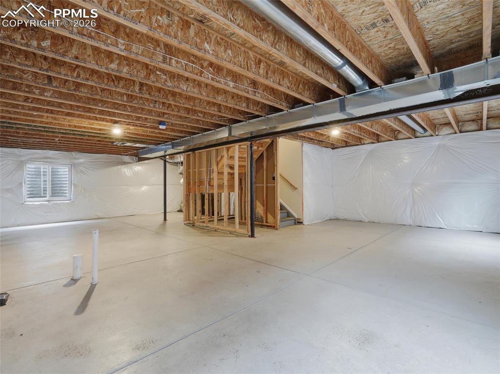 Image 38 of 45: Unfinished basement with stairway