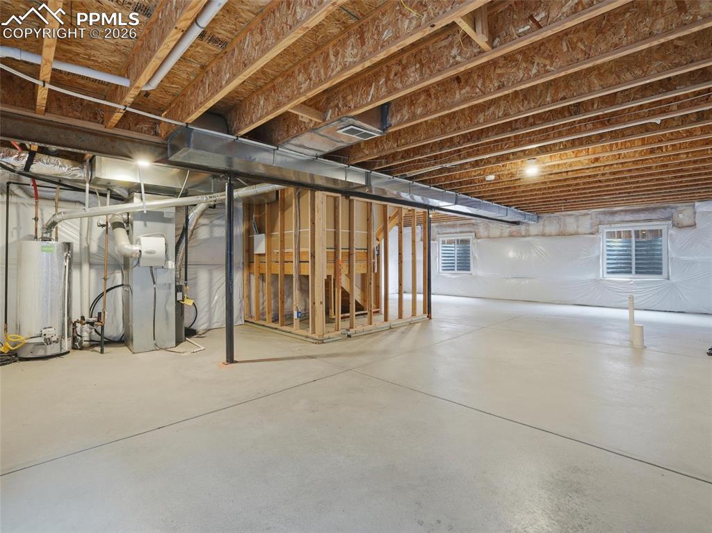 Image 39 of 45: Below grade area featuring gas water heater and heating unit