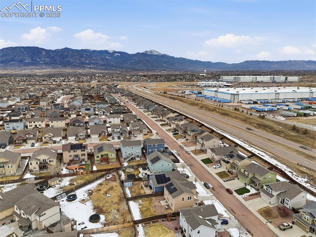 Image 43 of 45: Aerial perspective of suburban area featuring mountains
