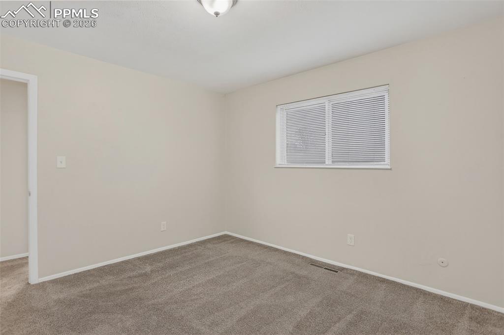 Image 19 of 44: Upper level Primary bedroom #1 with mirrored closet doors.