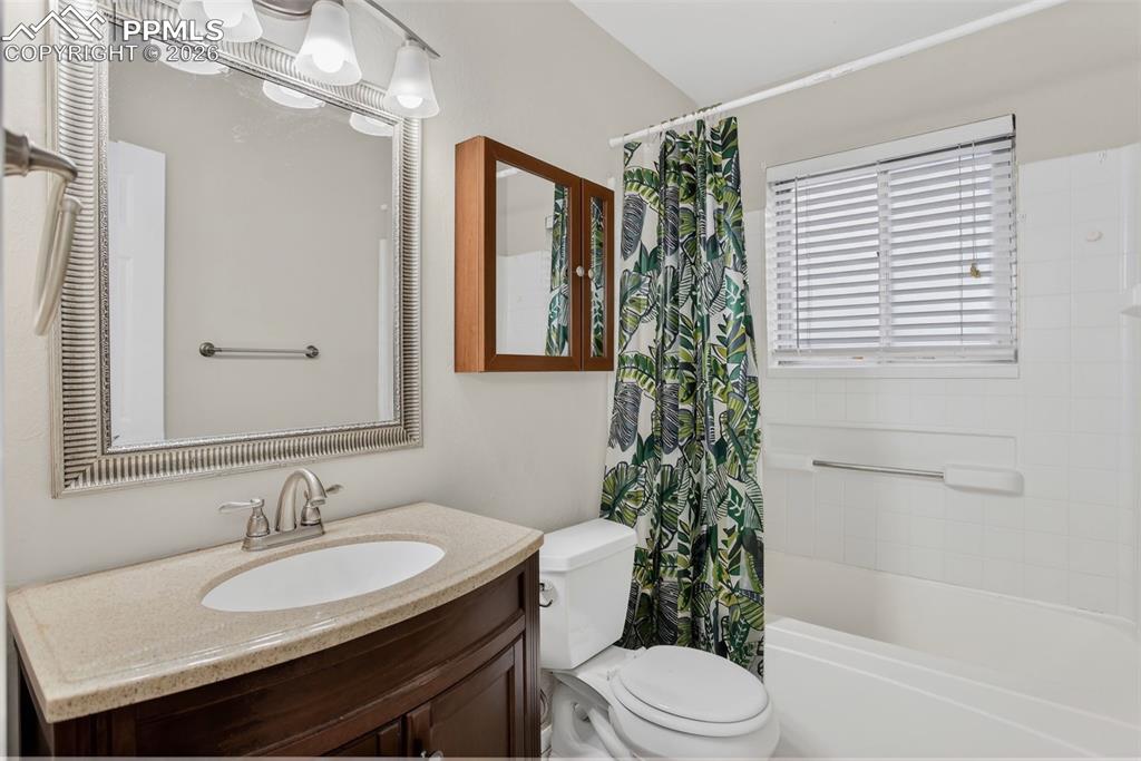 Image 20 of 44: Upper level Primary bedroom #1 with mirrored closet doors.