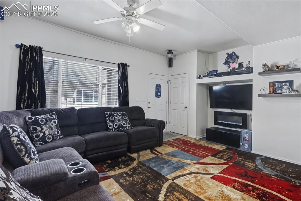 Image 4 of 15: Living room includes an electric fireplace