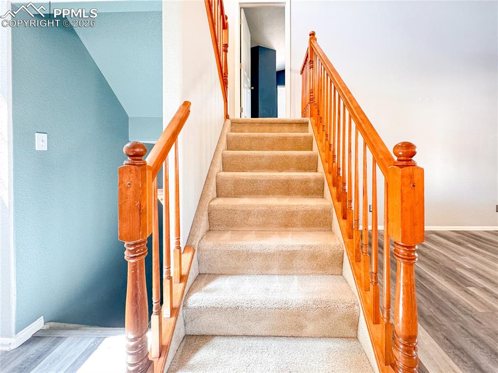Image 19 of 50: Stairs up to the primary bedroom