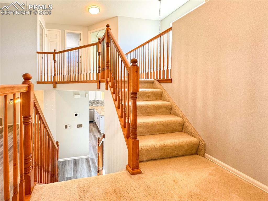Image 26 of 50: Stairs up to bedroom #2 and #3