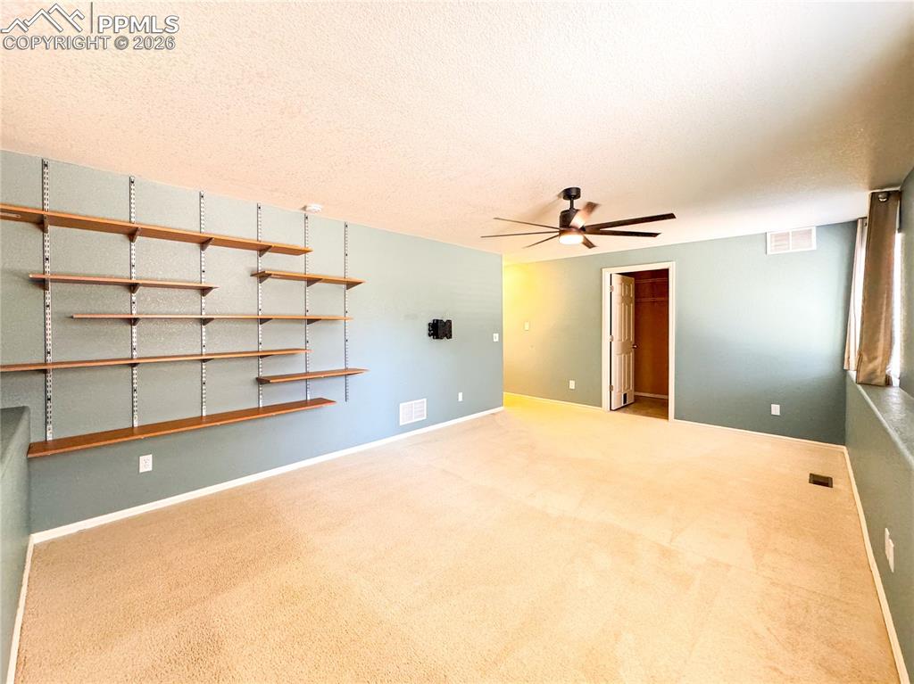 Image 32 of 50: Family room w/ shelves