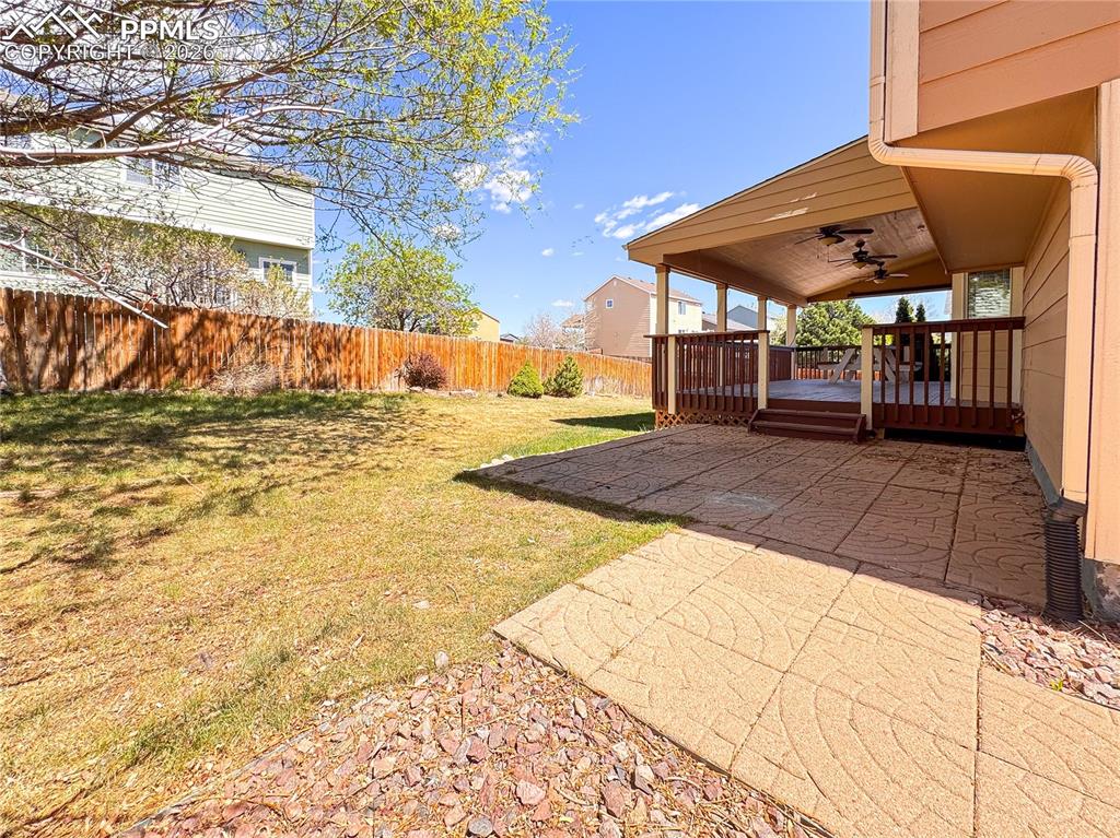 Image 40 of 50: Fenced in yard with patio