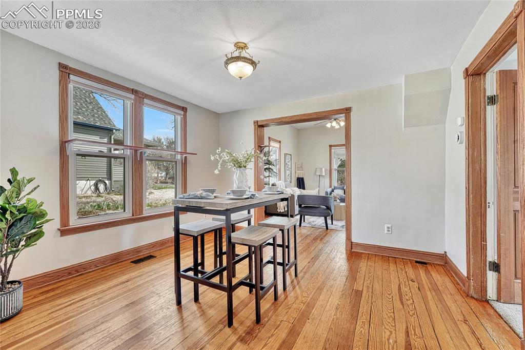 Image 13 of 42: Updated vinyl windows bring soft natural light into the spacious dining are