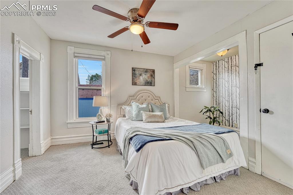 Image 15 of 42: The primary bedroom offers abundant comfort with cozy carpeting and a spaci