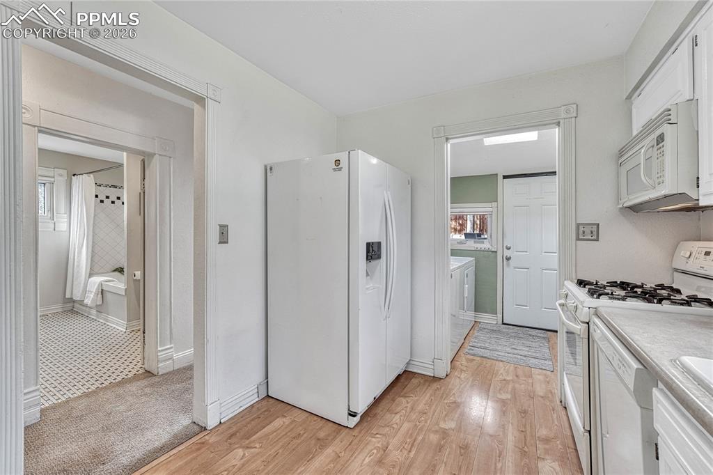 Image 21 of 42: The kitchen comes complete with a side-by-side refrigerator, built-in micro