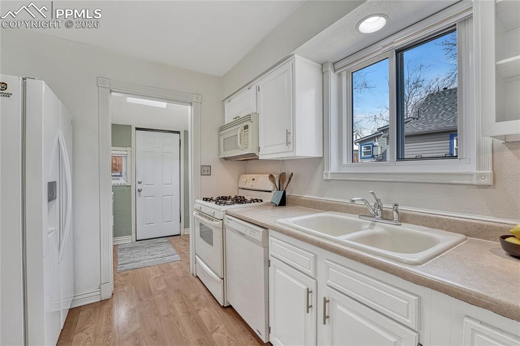 Image 22 of 42: Updated vinyl windows above the sink take full advantage of the home