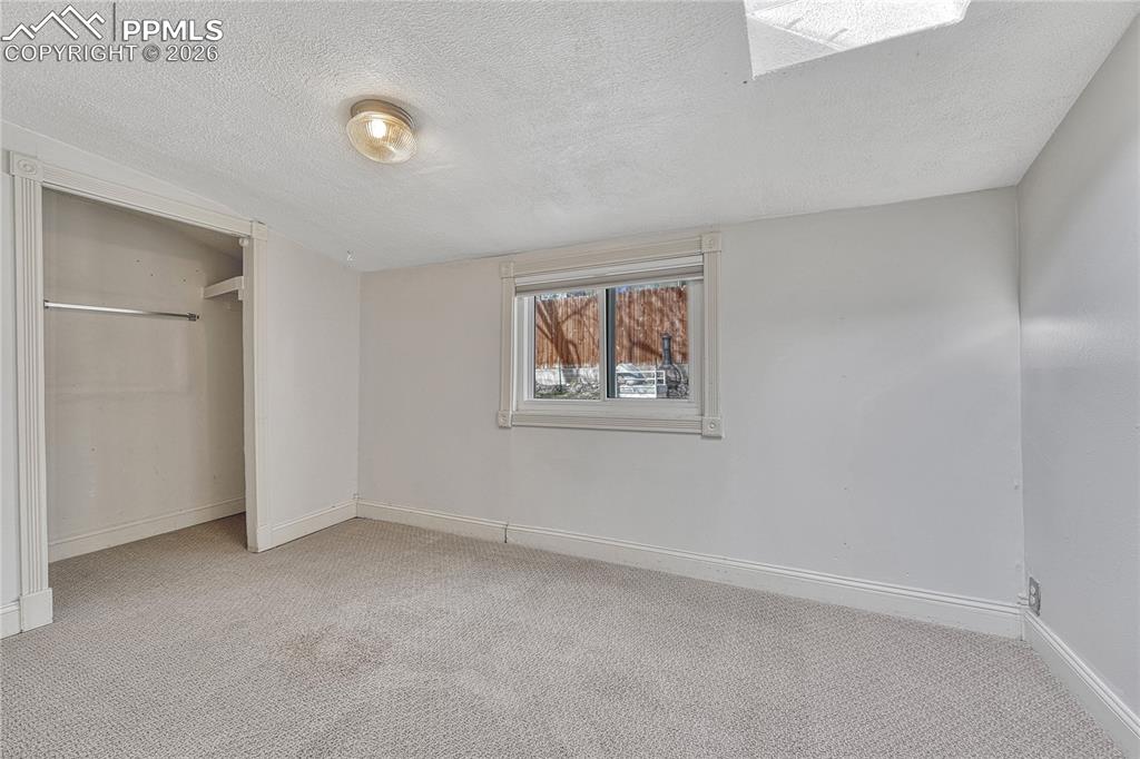 Image 27 of 42: Enjoy views of the west-facing backyard directly from this third bedroom /