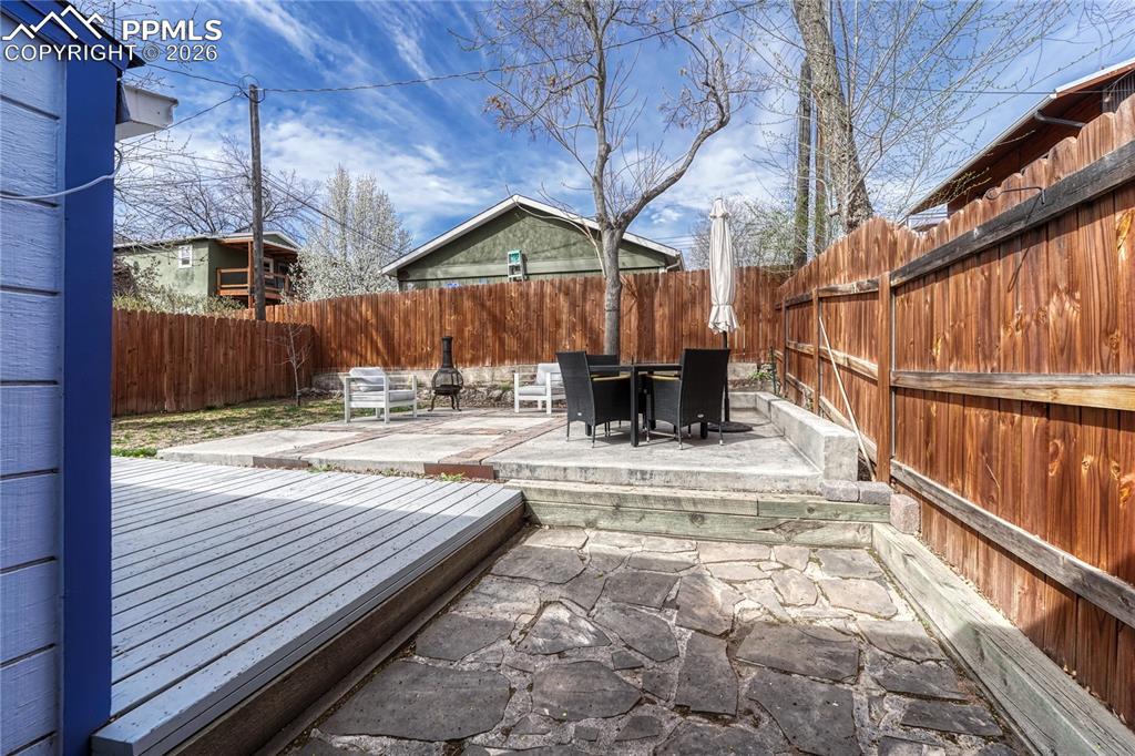 Image 28 of 42: The entertainment-friendly backyard features a custom paver and concrete pa