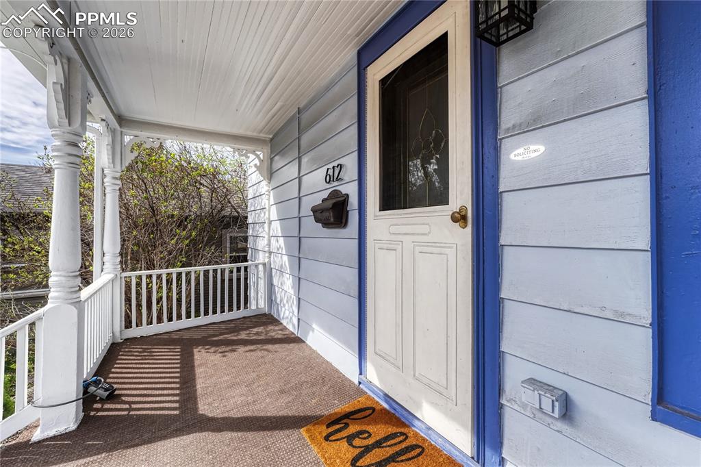 Image 3 of 42: The covered front porch provides a perfect vantage point to enjoy the chara