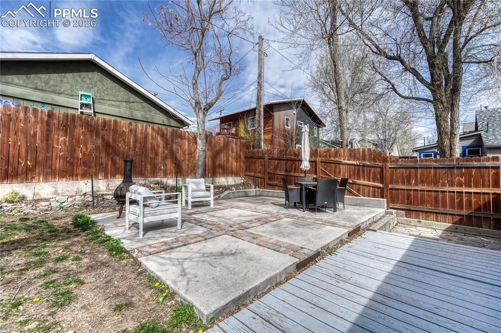 Image 30 of 42: A concrete and paver patio enhance this surprisingly spacious lot