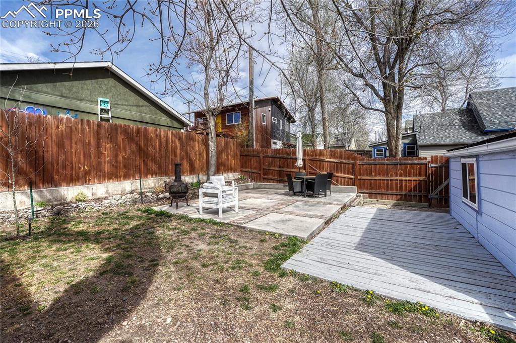 Image 31 of 42: A level greenspace and versatile outdoor seating areas make this backyard p