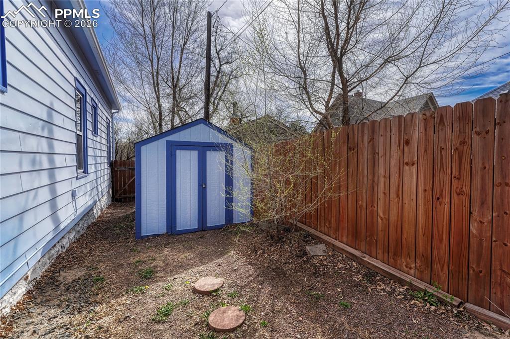 Image 34 of 42: An included outdoor storage shed provides practical space for gardening too