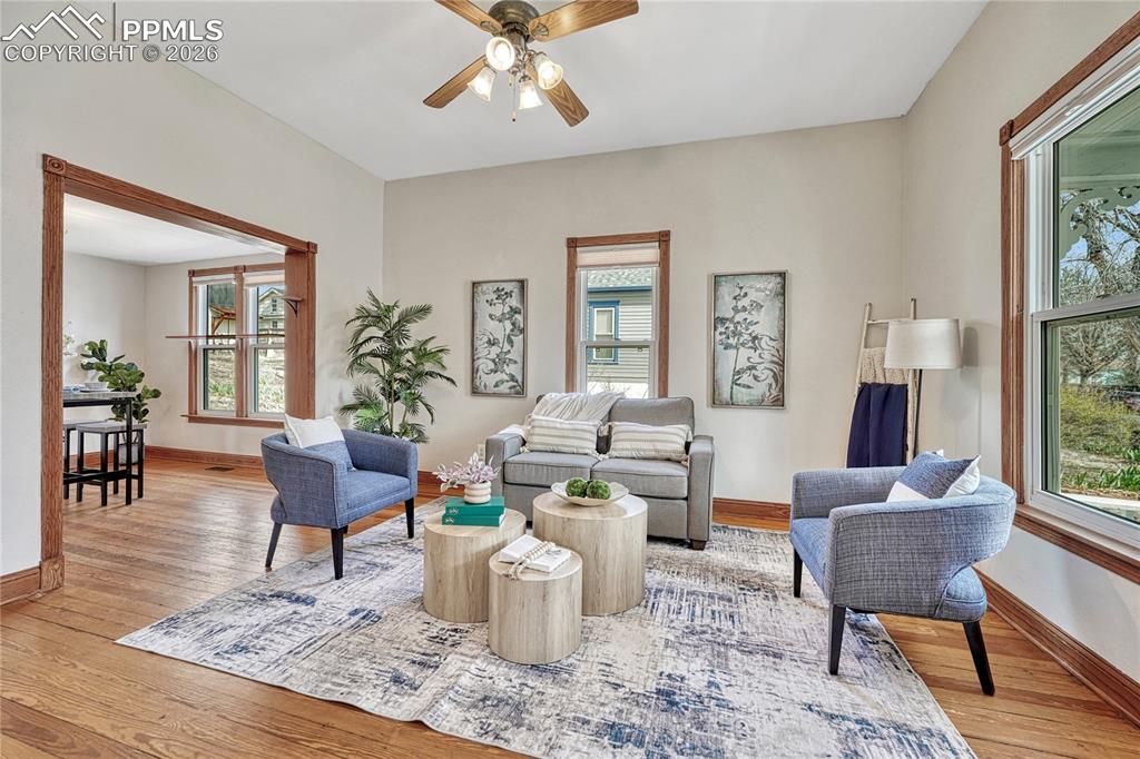 Image 5 of 42: Ample seating space and a cooling ceiling fan make the living room a comfor
