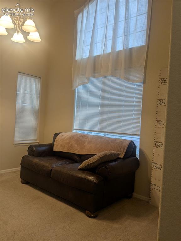 Image 3 of 33: Hallway featuring textured walls, neutral-toned flooring, and an arched ent