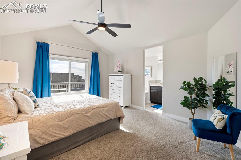 Image 10 of 45: Bedroom featuring carpet, vaulted ceiling, and ceiling fan