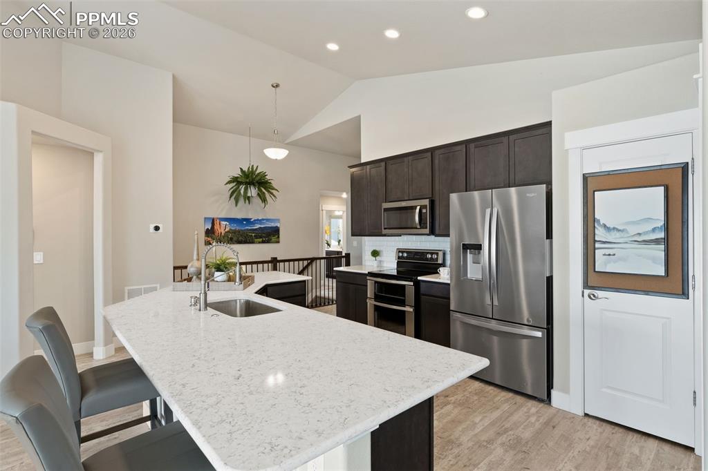 Image 19 of 45: Kitchen with stainless steel appliances, dark wood finish cabinets, a break