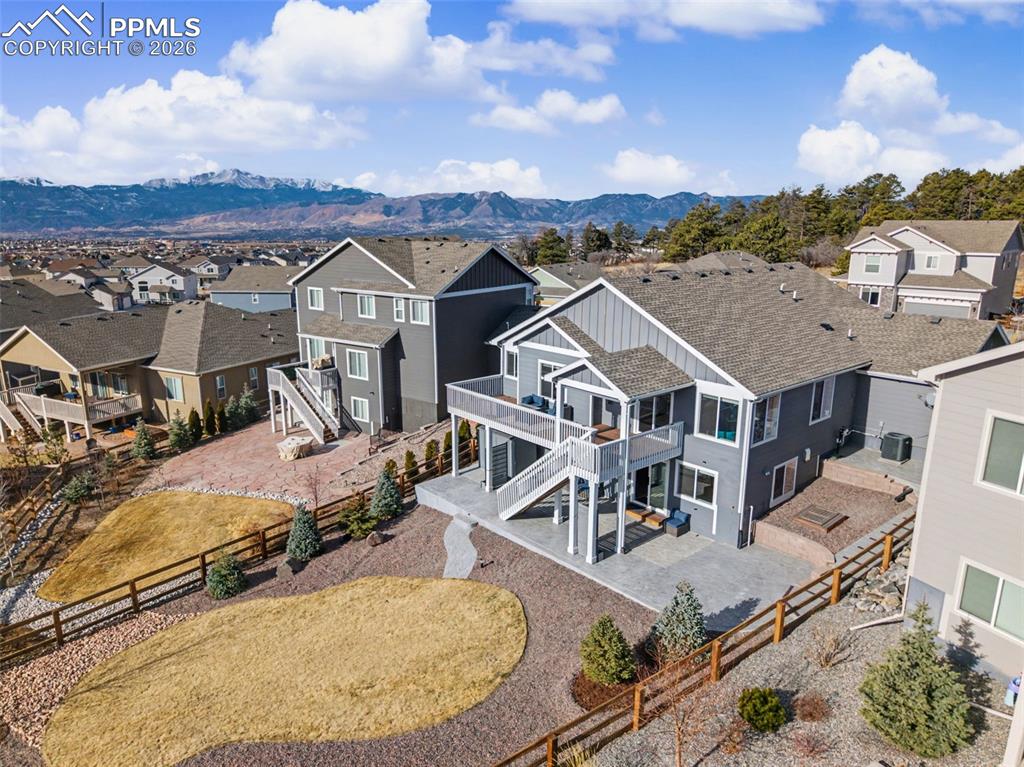 Image 2 of 45: Aerial view of residential area featuring a mountain backdrop