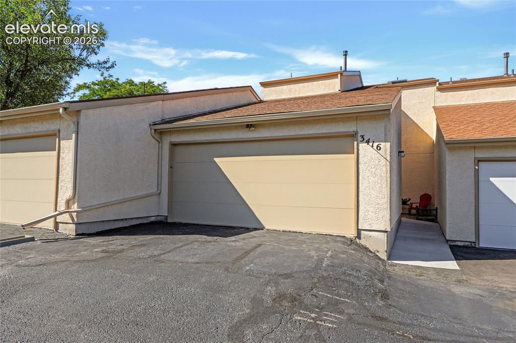 Caption: Garage with courtyard entryway