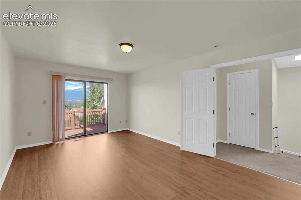 Image 4 of 33: Primary ensuite -upper level with deck and amazing views of Pikes Peak and