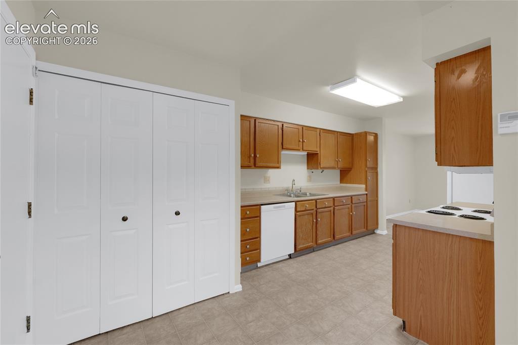 Image 8 of 33: View of Kitchen from Breakfast Nook. Laundry in double doors
