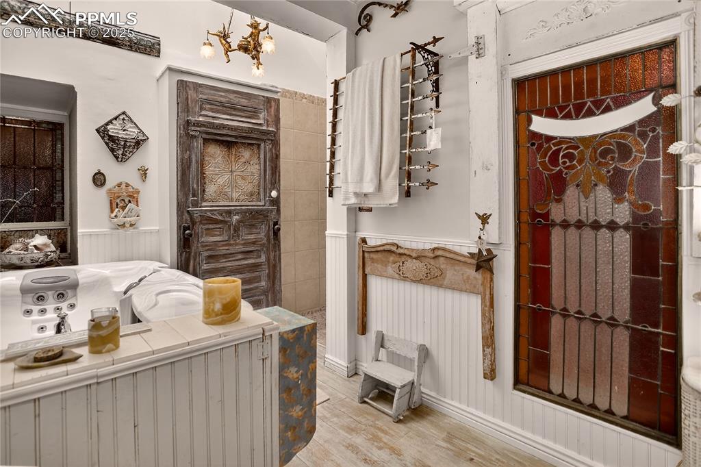 Image 33 of 41: Main bath w/ walk-in shower & skylight