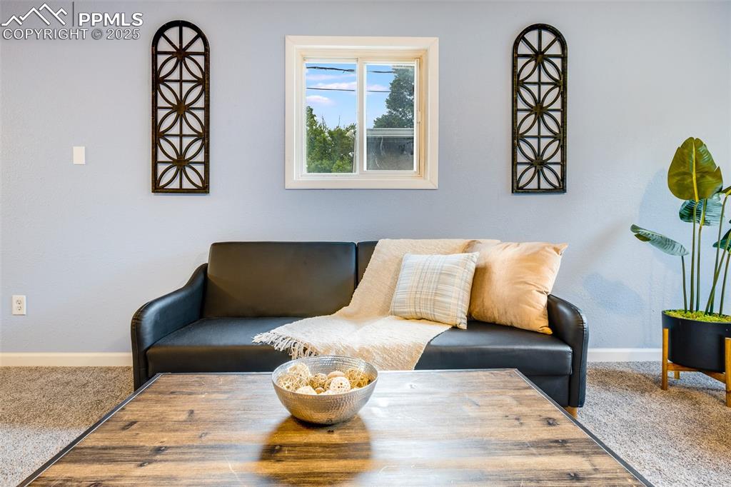 Image 10 of 24: Living area with carpet floors and baseboards