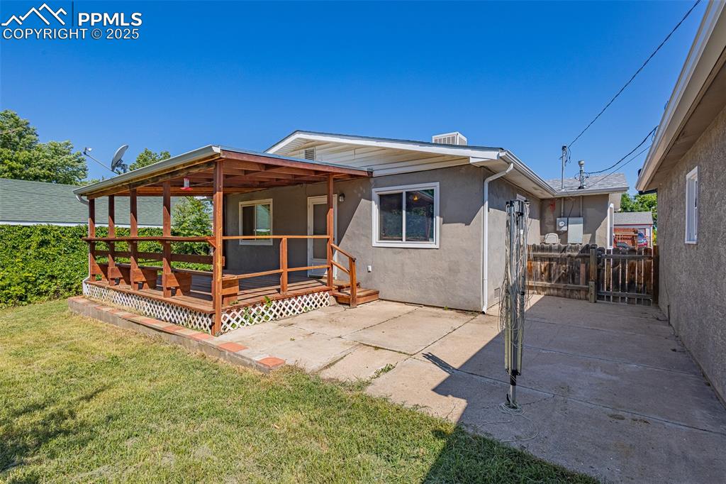 Image 14 of 24: Back of house featuring a deck, stucco siding, and a patio area