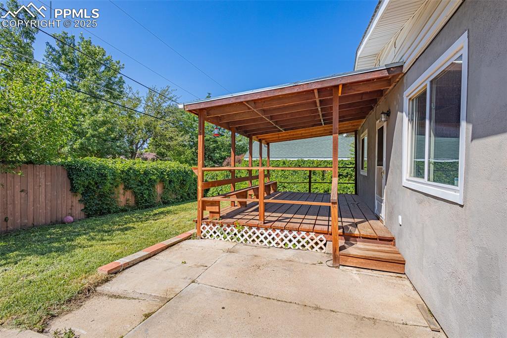 Image 16 of 24: View of patio with a wooden deck