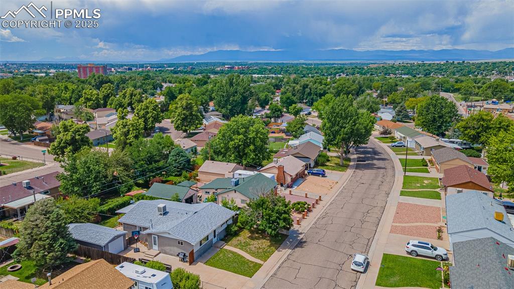 Image 23 of 24: Aerial perspective of suburban area with a mountain backdrop