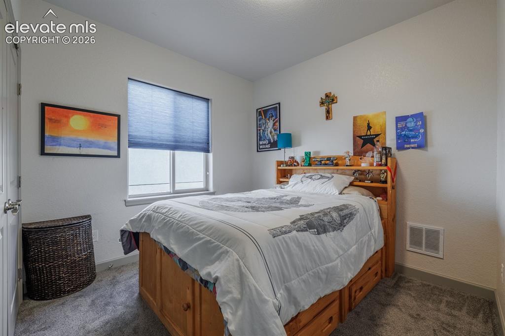 Image 12 of 16: Window with privacy blinds, light gray wall paint, and gray carpet flooring