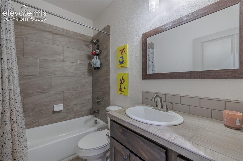 Image 13 of 16: Bathroom featuring a full-size tub, subway tile backsplash, wood-finish van