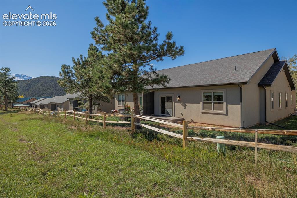 Image 16 of 16: Stucco exterior with a pitched roof, featuring a private patio, multiple wi