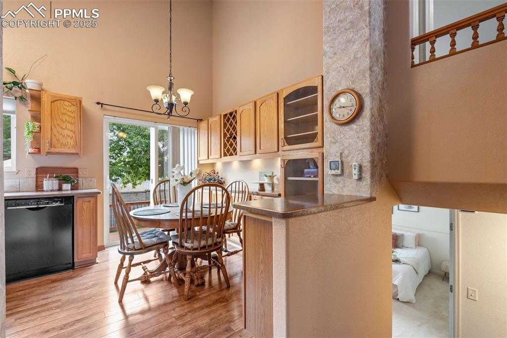 Image 18 of 36: Kitchen featuring hanging light fixtures, dishwasher, a peninsula, a toweri