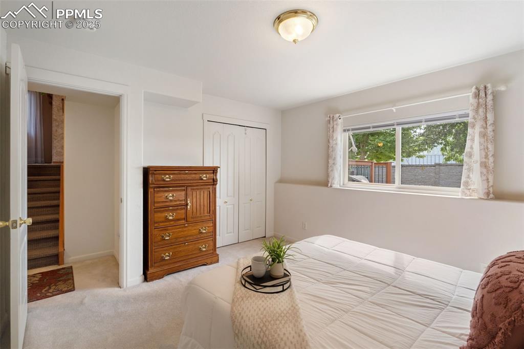 Image 20 of 36: Bedroom with carpet and a closet