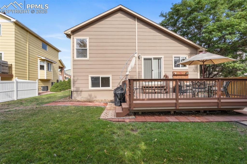 Image 28 of 36: Back of house featuring a wooden deck
