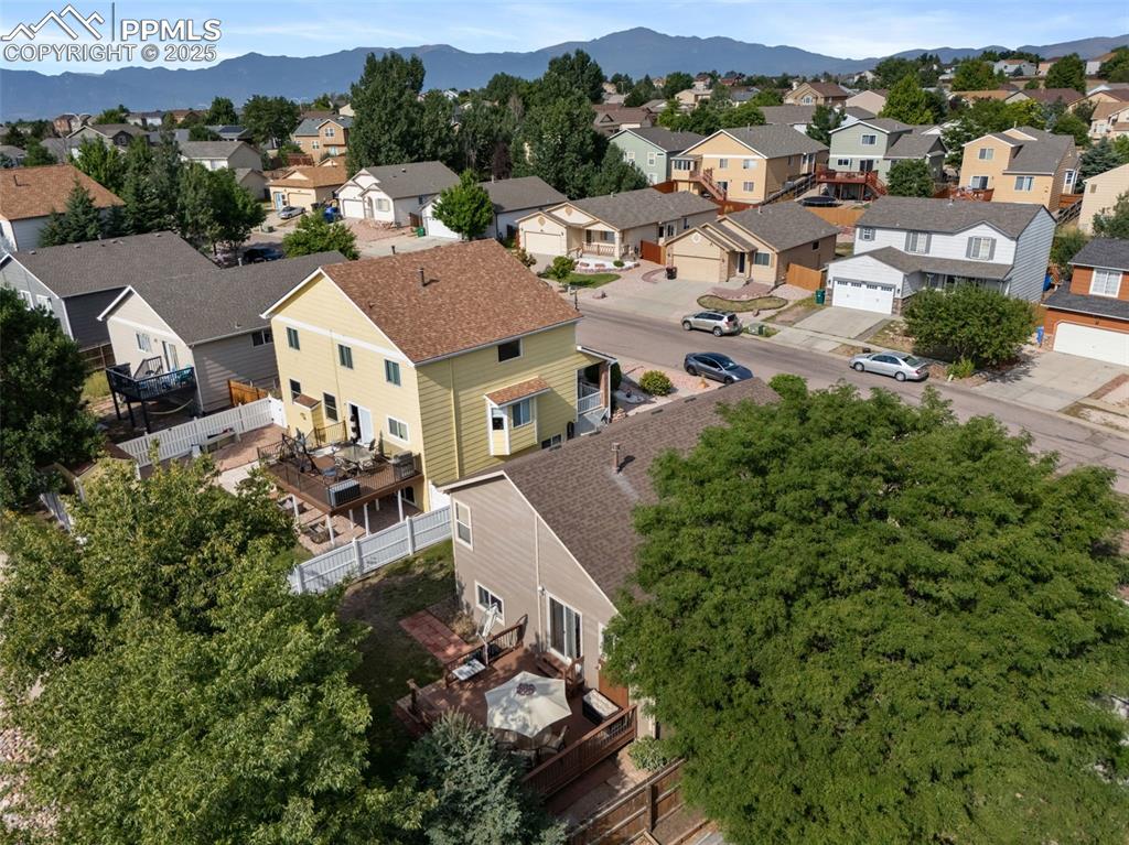 Image 31 of 36: Aerial perspective of suburban area with a mountainous background