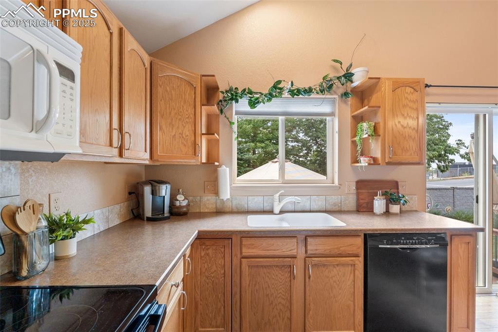 Image 6 of 36: Kitchen featuring open shelves, white microwave, dishwasher, range with ele