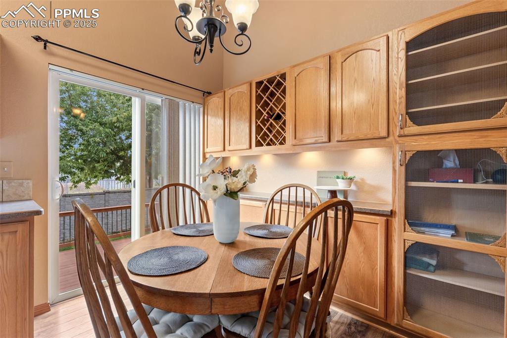 Image 9 of 36: Dining space with a chandelier and light wood finished floors