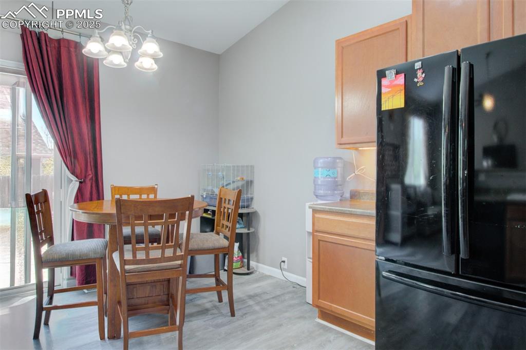Image 11 of 21: Dining space featuring a chandelier and light wood-style floors