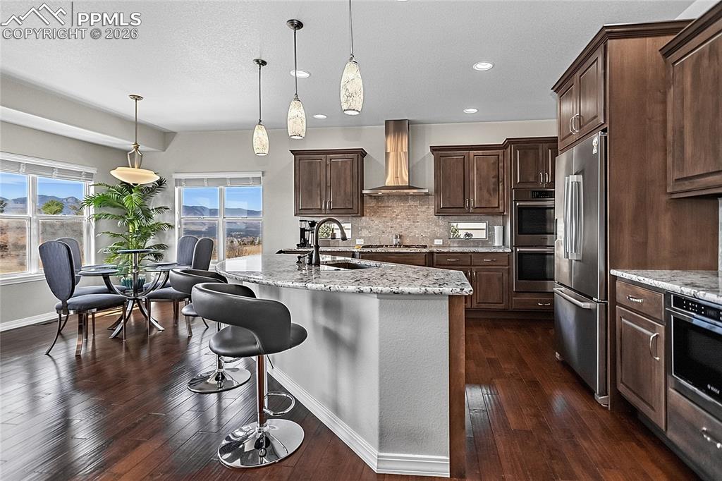 Image 15 of 50: Enjoy your coffee at the breakfast bar or in the dining area while watching