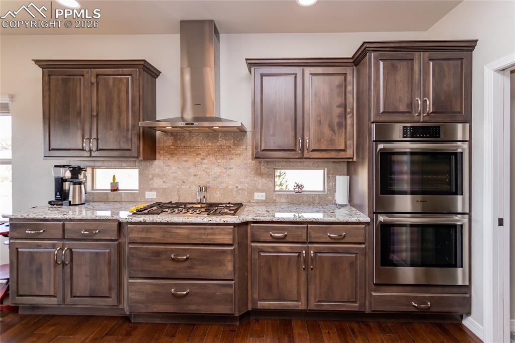 Image 18 of 50: Cabinets galore with double oven & gas range top