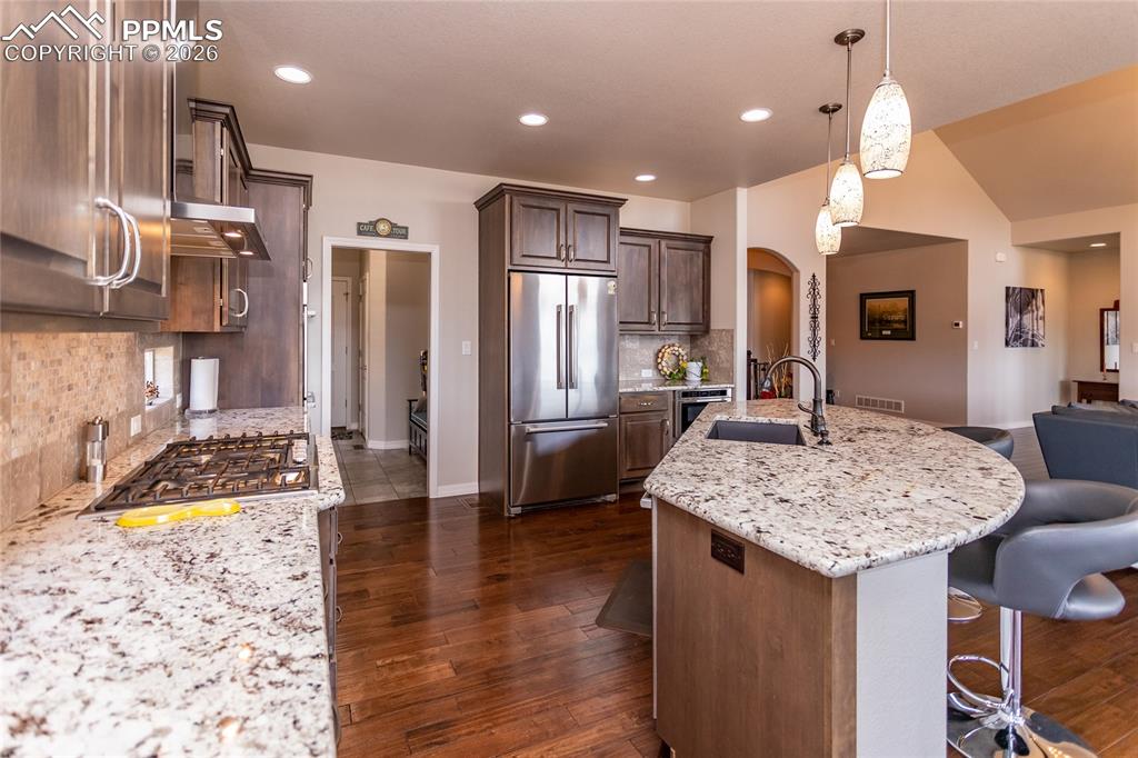 Image 19 of 50: Stainless steel appliances that are just steps away from the walk-in pantry